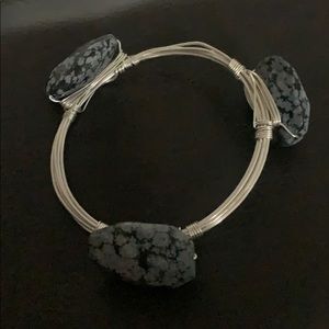 Silver wire bracelet with black and gray stones.